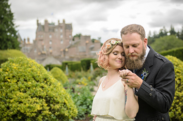 Relaxed bride portrait in the garden of Scottish hotel by wedding photographer Alexander Whyte